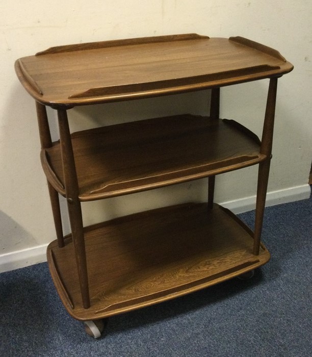 An Ercol three tier tea trolley. Est. £50 - £80.