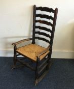 An Antique oak rocking chair with cane seat. Est.