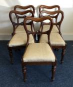 A set of five rosewood hoop back chairs with slip-
