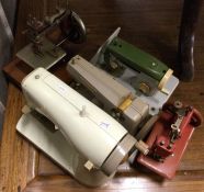 A child's Singer sewing machine together with four