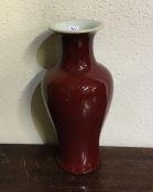 An unusual Chinese red glazed baluster shaped vase