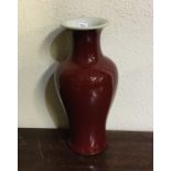 An unusual Chinese red glazed baluster shaped vase