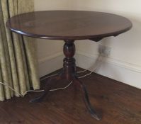 A large Georgian tilt top mahogany table on turned
