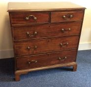 A Georgian mahogany chest of five drawers on brack