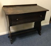An oak single drawer side table with stretcher bas