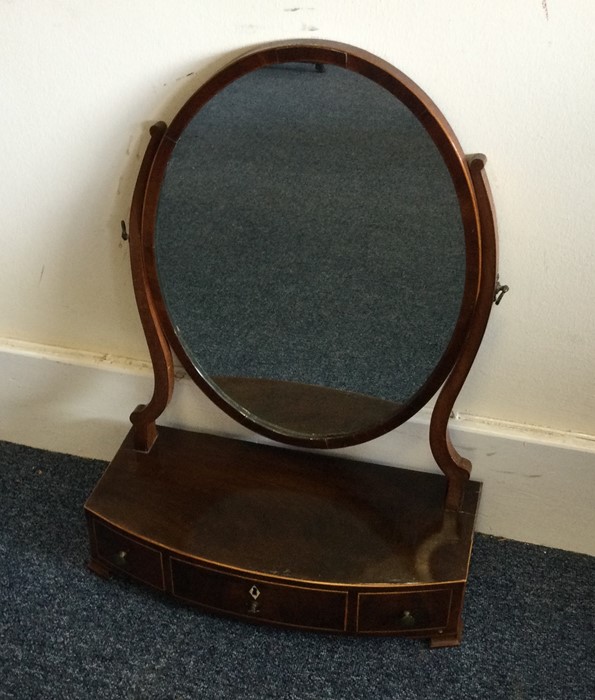 A Georgian mahogany toilet mirror of circular form