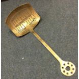 A large Antique brass skimmer with pierced bowl. E