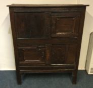 A good early oak hall cupboard with panelled front