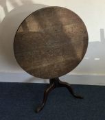 A Georgian oak tilt top table. Est. £30 - £50.