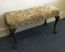 An Edwardian mahogany upholstered duet stool with