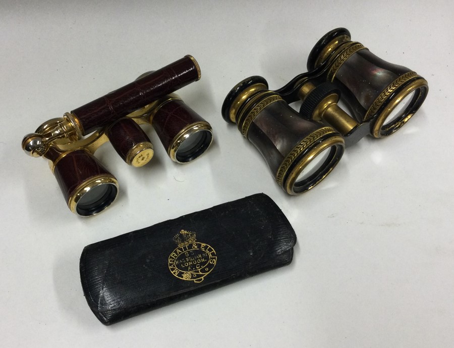 Two pairs of gilt opera glasses. Est. £30 - £50.