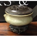 A Chinese celadon pot pourri with hardwood cover a