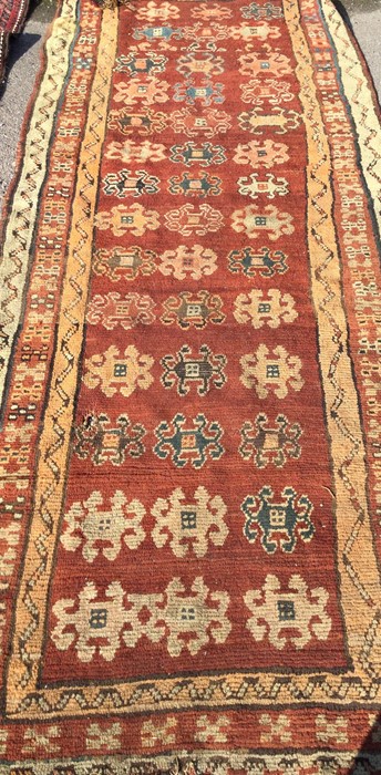 An old red ground runner. Est. £20 - £30.