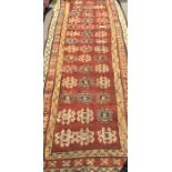 An old red ground runner. Est. £20 - £30.