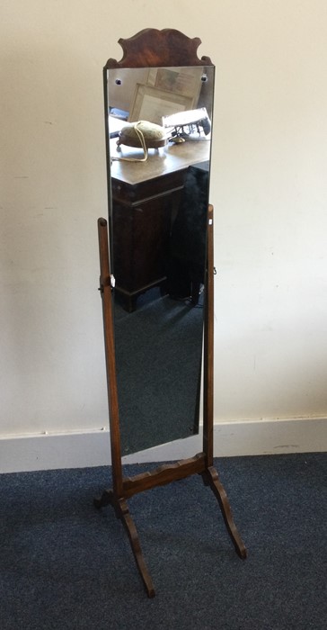 A mahogany dressing mirror on four spreading suppo