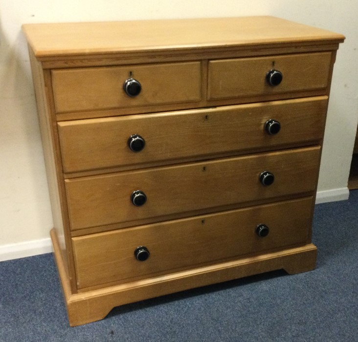 A good pine chest of five drawers with shaped deco