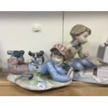 A Lladro figure of a child with dog together with