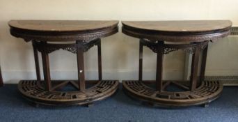 A good pair of 19th Century demi-lune tables of Or