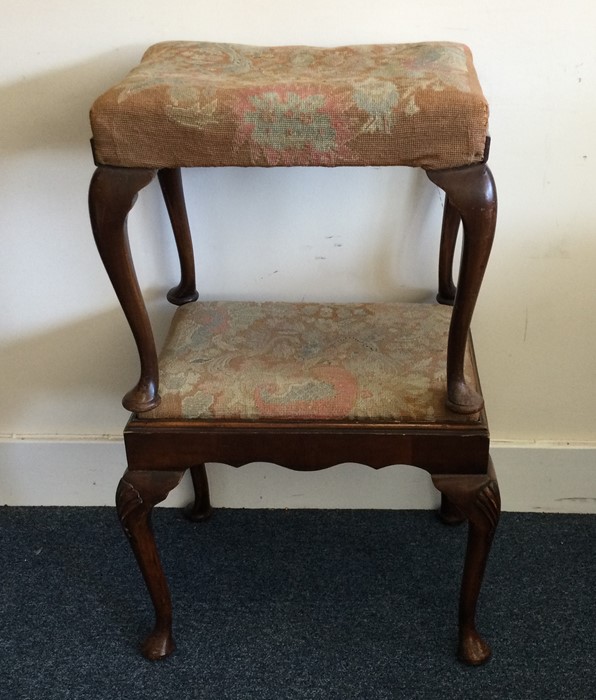 Two Edwardian mahogany upholstered stools on cabri