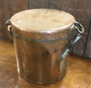 A large copper cooking pot and cover. Est. £30 - £