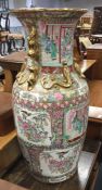 A tall Chinese vase decorated in bright colours. A