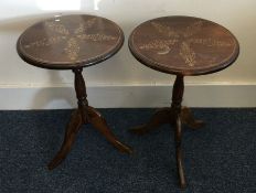 A pair of mahogany pedestal tables with floral dec