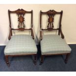 A pair of Victorian rosewood writing chairs with i