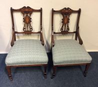 A pair of Victorian rosewood writing chairs with i