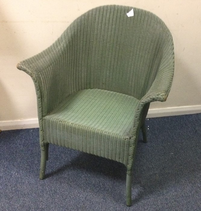 A green Lloyd Loom armchair. Est. £30 - £50.