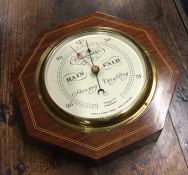 An Edwardian wall mounted barometer. By Short & Ma