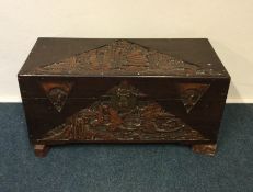 A 20th Century carved camphorwood trunk with hinge