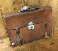 An old leather satchel. Est. £10 - £20.