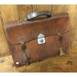 An old leather satchel. Est. £10 - £20.