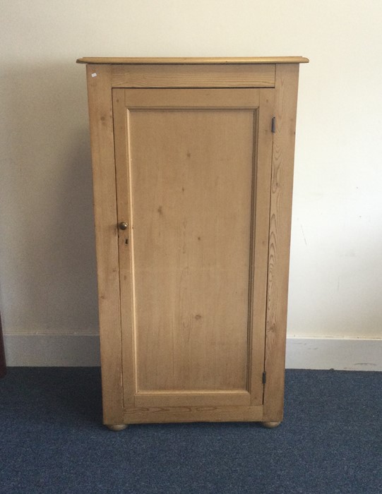 A tall stripped pine housekeeper's cupboard with p