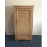 A tall stripped pine housekeeper's cupboard with p