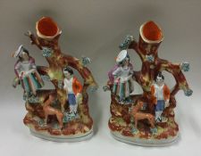 A pair of Staffordshire vases. Est. £20 - £30.