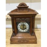 A large mahogany shaped top mantle clock with pill