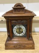 A large mahogany shaped top mantle clock with pill