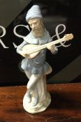 A tall Nao figure of a musician. Approx. 26 cms hi