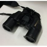 A cased pair of Nikon binoculars. Est. £30 - £50.