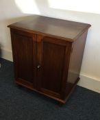 An early Victorian two door mahogany side cabinet