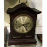 An oak cased shaped top clock with silvered dial.
