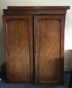 A large Georgian mahogany two door panelled wardro