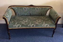 An upholstered chaise longue on tapering feet. Est