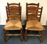 A set of four Edwardian oak dining chairs with can