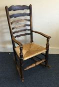 A Georgian style rocking chair with turned support