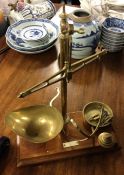 A set of old brass kitchen scales. Est. £25 - £30.