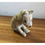 STEIFF: A miniature preloved figure of a dog. Est.