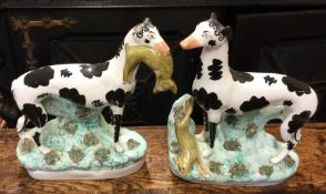 A pair of large Staffordshire greyhounds on textur
