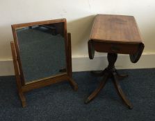 A mahogany drop leaf pedestal table together with
